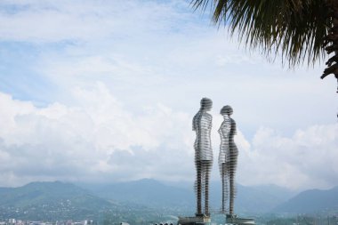 BATUMI, GEORGIA - JUNE 14, 2022: Movable sculptural composition Ali and Nino with breathtaking landscape on background