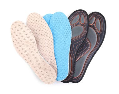 Pairs of different insoles on white background, top view