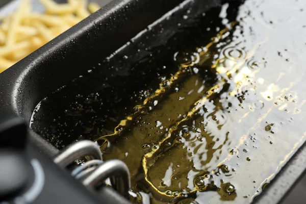 Hot cooking oil in deep fryer, closeup