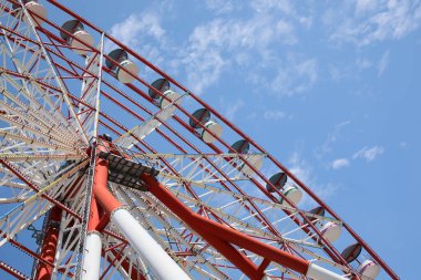 Beautiful large Ferris wheel against blue sky, low angle view