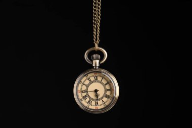 Beautiful vintage pocket watch with chain on black background. Hypnosis session