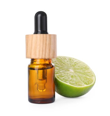 Bottle of citrus essential oil and cut fresh lime isolated on white