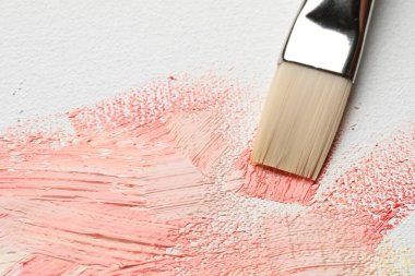 Painting beautiful strokes of colorful oil paints on canvas, closeup