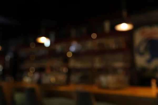 Blurred view of stylish modern bar interior with bokeh effect