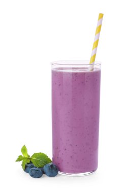 Glass of blueberry smoothie with fresh berries and mint on white background