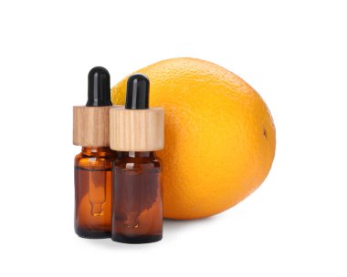 Bottles of citrus essential oil and fresh orange isolated on white