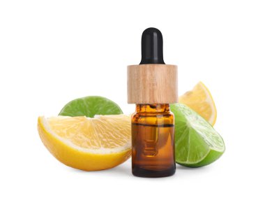 Bottle of citrus essential oil and cut fresh fruits isolated on white