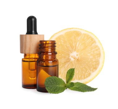 Bottles of citrus essential oil and fresh lemon isolated on white