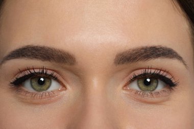 Young woman with permanent makeup of eyes and brows, closeup