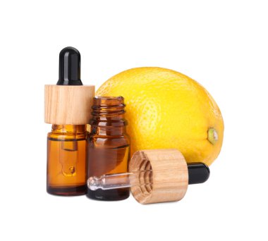 Bottles of citrus essential oil and fresh lemon isolated on white