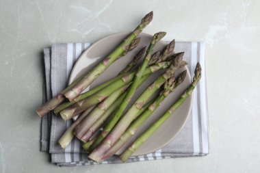 Fresh raw asparagus on light grey marble table, flat lay