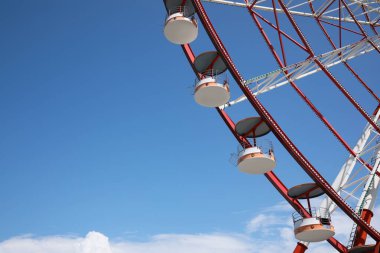 Beautiful large Ferris wheel against blue sky, low angle view