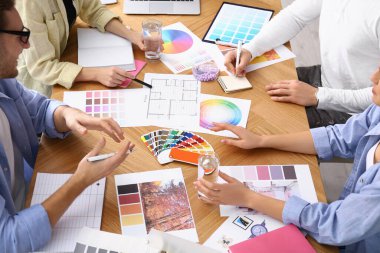 Professional team of interior designers working at table, closeup