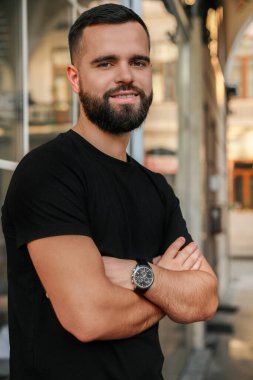Portrait of happy handsome man near building outdoors