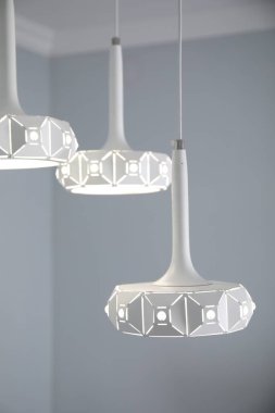 Stylish white pendant lamp in light room