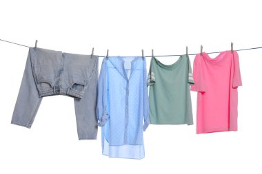 Different clothes drying on washing line against white background