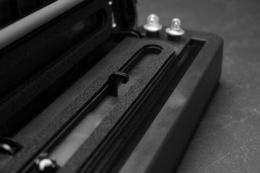 Sealer for vacuum packing on slate table, closeup