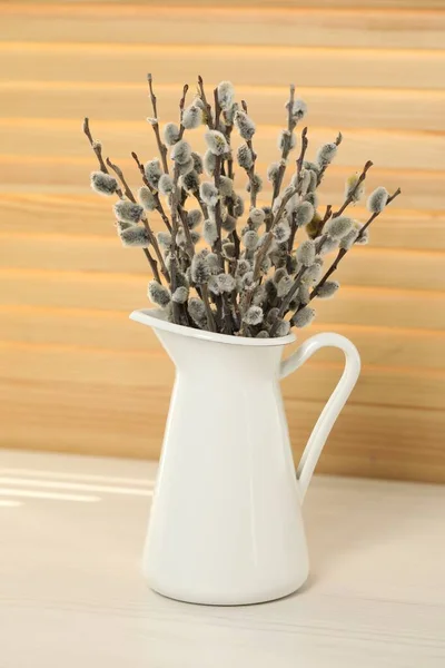 Beautiful pussy willow branches in vase on white table