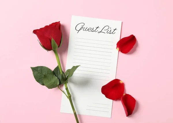 Guest list and beautiful red rose on pink background, flat lay