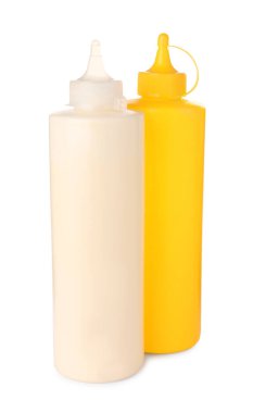 Plastic bottles of tasty mayonnaise and mustard on white background