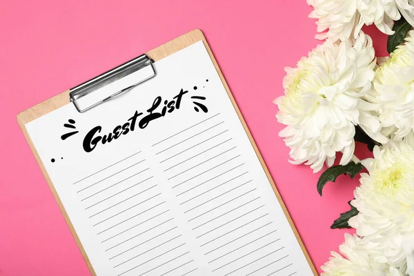 Guest list and beautiful white chrysanthemum flowers on pink background, flat lay
