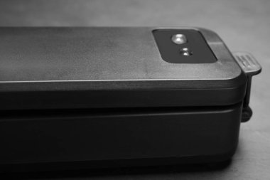 Sealer for vacuum packing on slate table, closeup