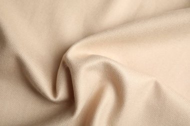 Arka plan olarak bej yumuşak kaşmir kumaş, yakın plan