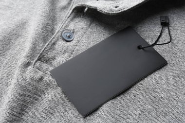 Blank tag on tshirt, closeup view. Space for text