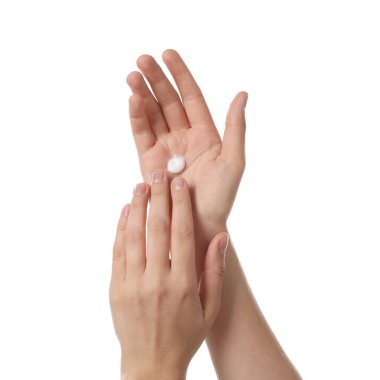 Woman applying cream on hand against white background, closeup