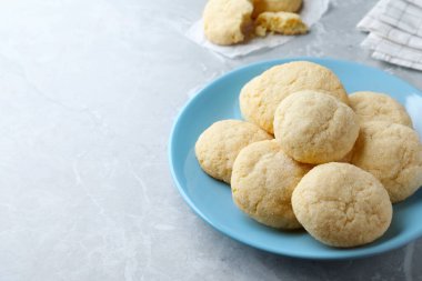 Delicious sugar cookies on light grey marble table, space for text