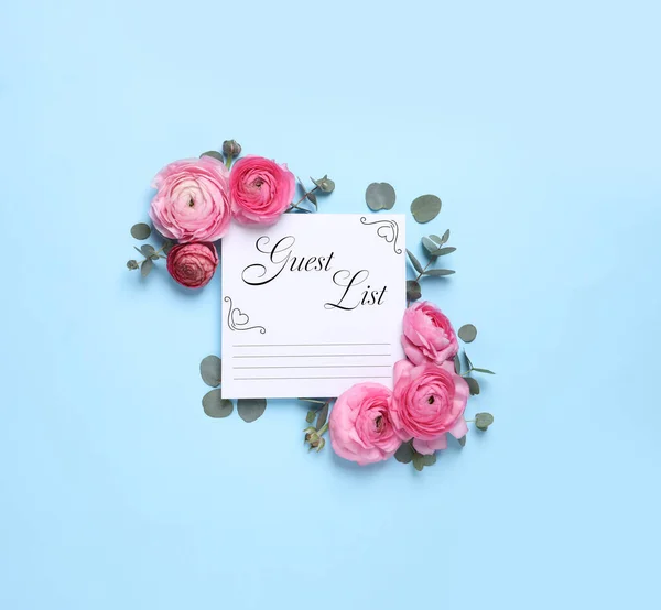 Beautiful flowers and guest list on light blue background, flat lay
