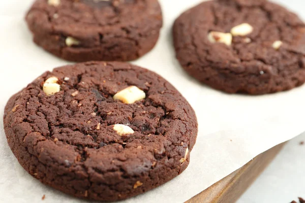 Delicious chocolate cookies on board, closeup view