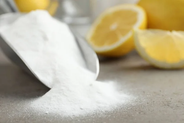 Baking soda and cut lemons on light table, closeup