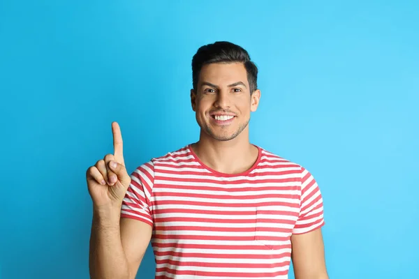 Man Showing Number One His Hand Light Blue Background — Foto de Stock