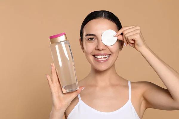 Young Woman Using Cotton Pad Micellar Water Beige Background —  Fotos de Stock