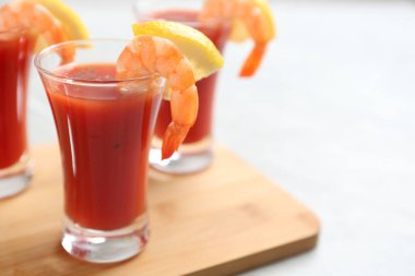 Delicious shrimp cocktail with tomato sauce served on  table, closeup. Space for text