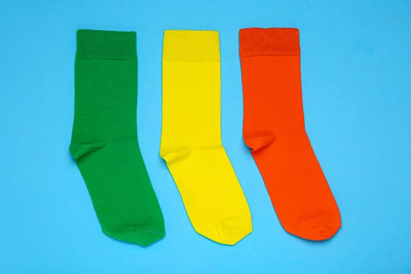 Different Socks Light Blue Background Flat Lay — стоковое фото