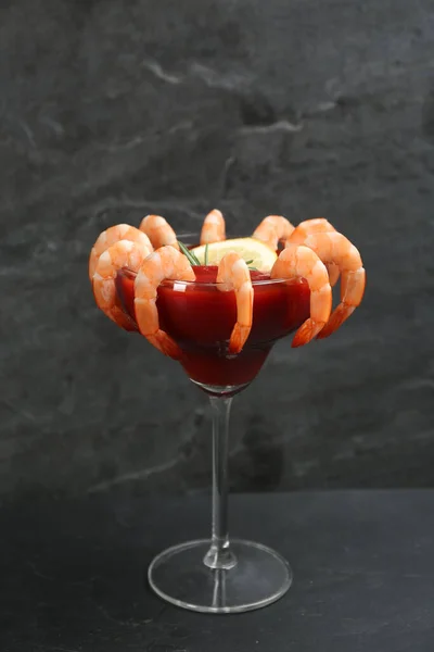 Delicious shrimp cocktail with tomato sauce served on black table