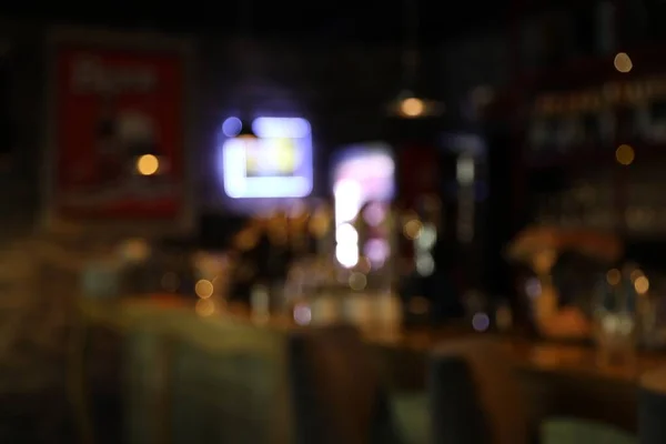 Blurred view of stylish modern bar interior with bokeh effect