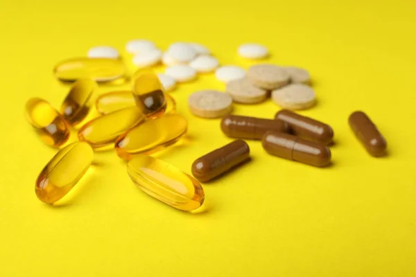 Different Dietary Supplements Yellow Background Closeup — Fotografia de Stock