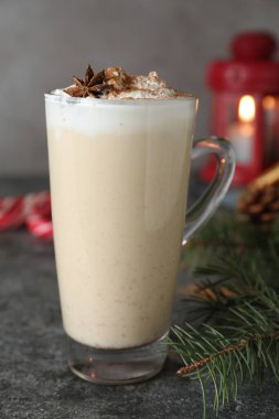 Delicious Christmas cocktail with liqueur on grey table, closeup