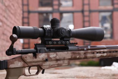 Closeup view of modern powerful sniper rifle with telescopic sight outdoors