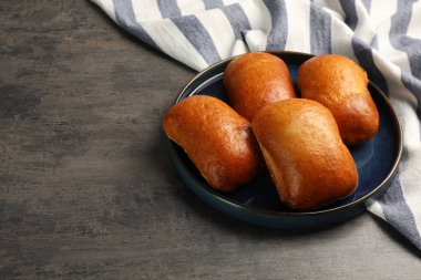 Delicious baked patties on grey table, space for text