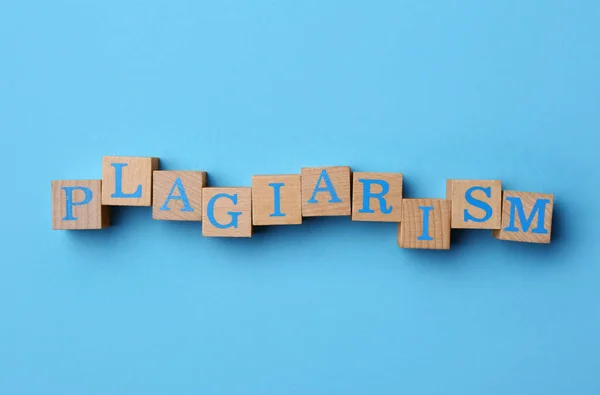 Word Plagiarism Made Wooden Cubes Letters Light Blue Background Top — Foto de Stock