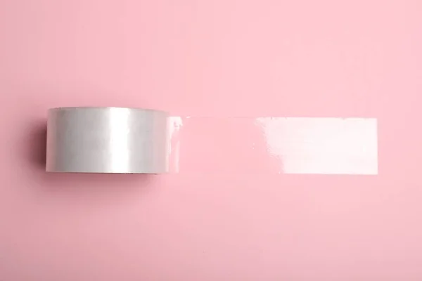 Roll Adhesive Tape Pink Background Top View — стоковое фото