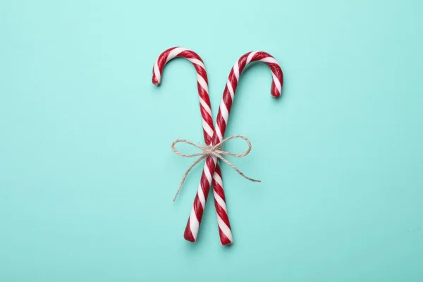 Two Sweet Christmas Candy Canes Bow Turquoise Background Top View — Foto de Stock