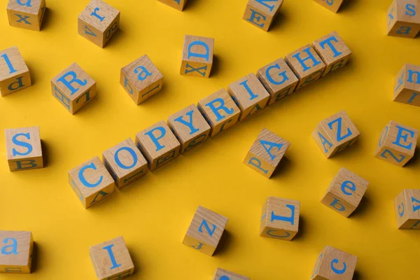Plagiarism Concept Word Copyright Made Wooden Cubes Letters Yellow Background — Foto de Stock