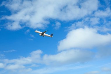 Beautiful view of modern airplane in blue sky. Space for text
