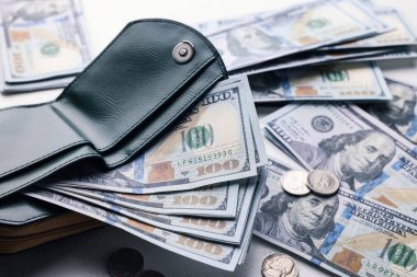Dollar banknotes, coins and wallet on white table, closeup. Money exchange