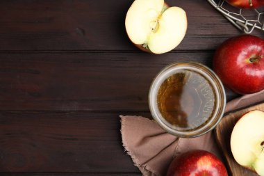 Flat lay composition with delicious apple cider on wooden table. Space for text